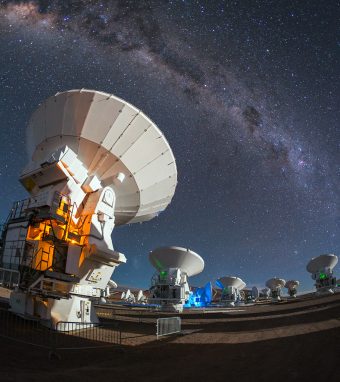 The antennas of the Atacama Large Millimeter/submillimeter Array (ALMA) look up into the night sky to observe the band of the Milky Way.